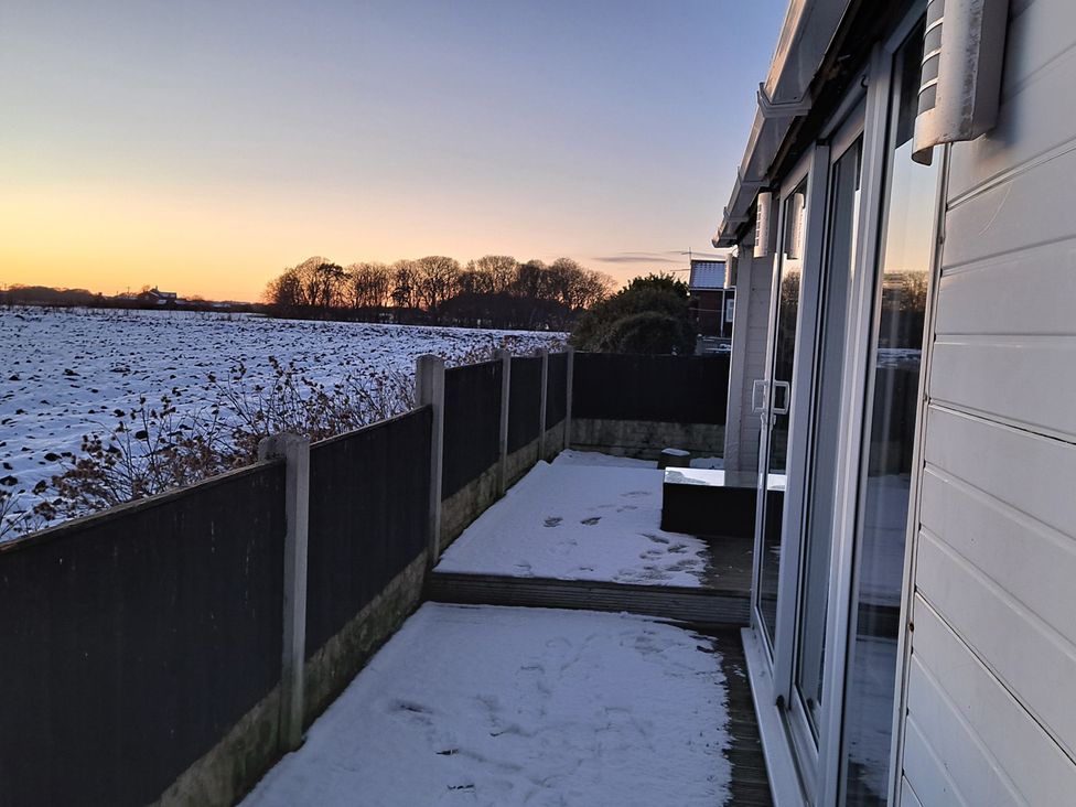 An outdoor area with snow and a fence at Sea View Retreat in Bridlington