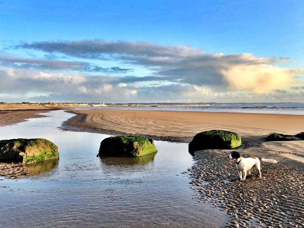 A beach with water and rocks at Sea View Retreat in Bridlington