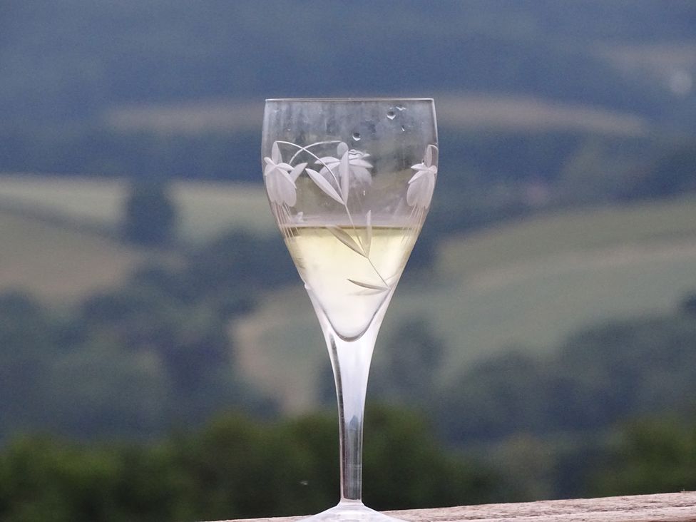 A glass with a beverage in an outdoor setting at Cosy Shepherd’s Hut Longhope