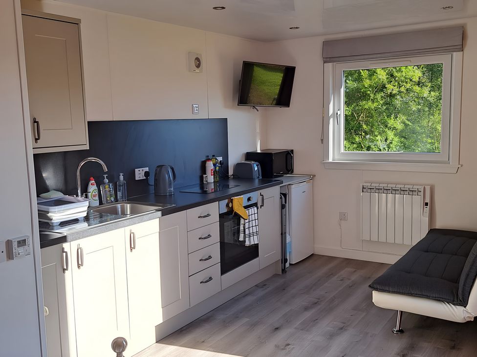 A kitchenette with a sink and appliances at The Posh Bothy 2 Roy Bridge