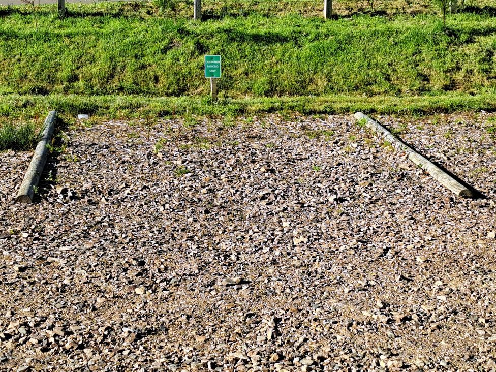 An outdoor area with gravel and wooden posts at The Posh Bothy 2 in Roy Bridge