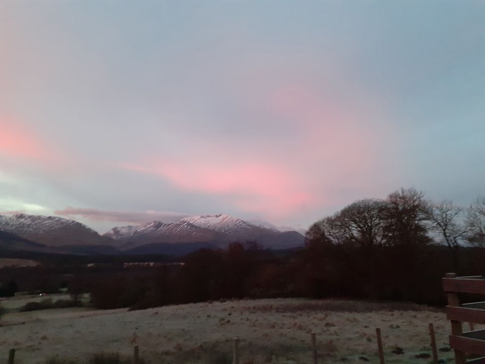 A view of mountains and sky with trees at The Posh Bothy 2 in Roy Bridge