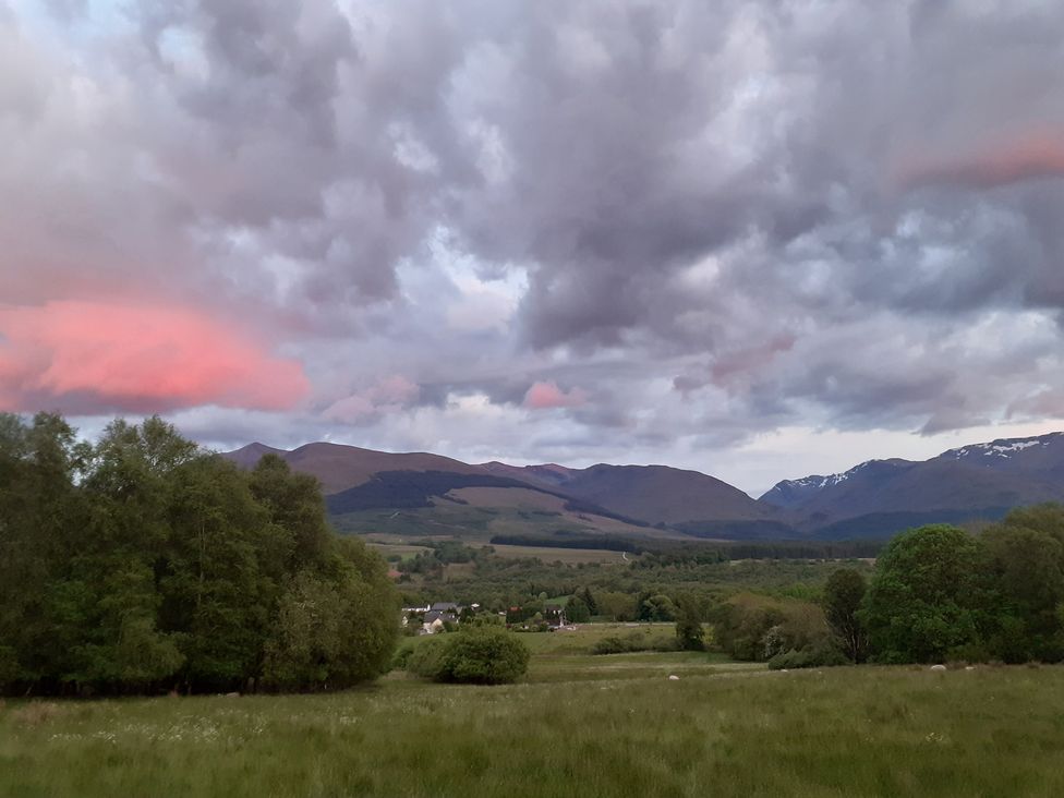 A scenic view of mountains and fields at The Posh Bothy 2 in Roy Bridge