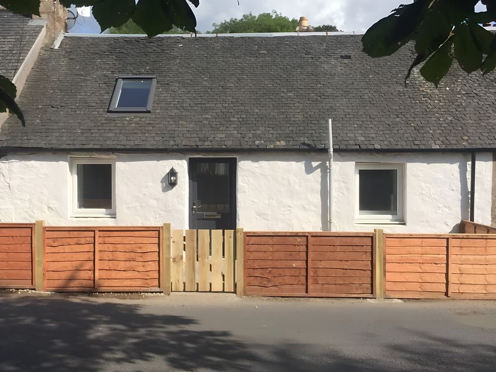 A house with a fence and door at Shedog Cottage Isle of Arran