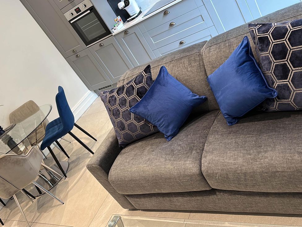 A living room with sofa and dining table at Apartment 2 in Preston, Lancashire