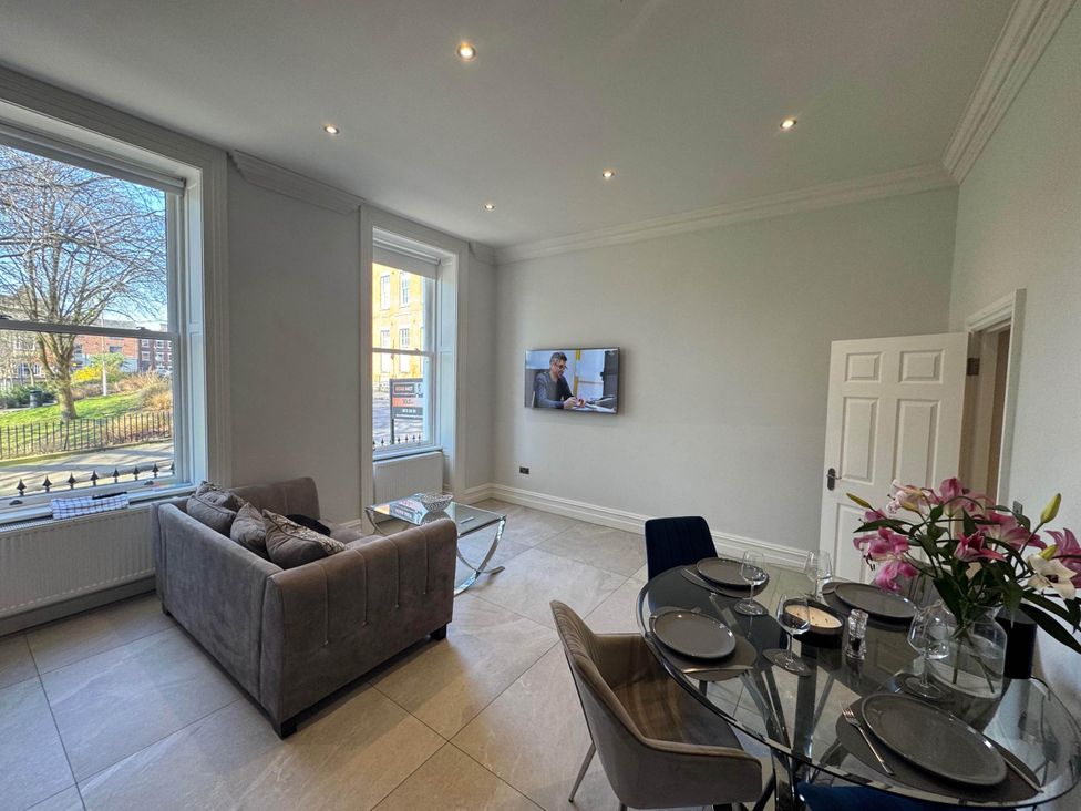 A living room with a sofa and dining table at Apartment 2 in Preston, Lancashire