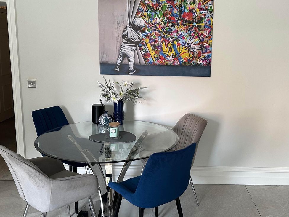 A dining room with a round table and chairs at Apartment 2 in Preston, Lancashire