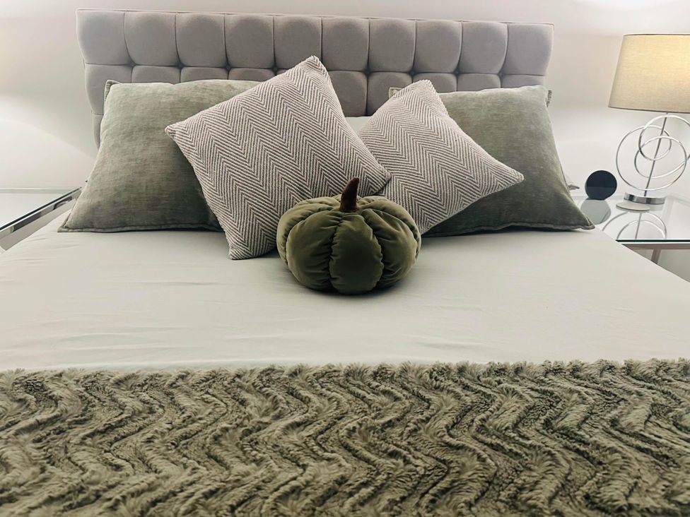 A bedroom with a bed and decorative pillows at Apartment 2 Preston, Lancashire