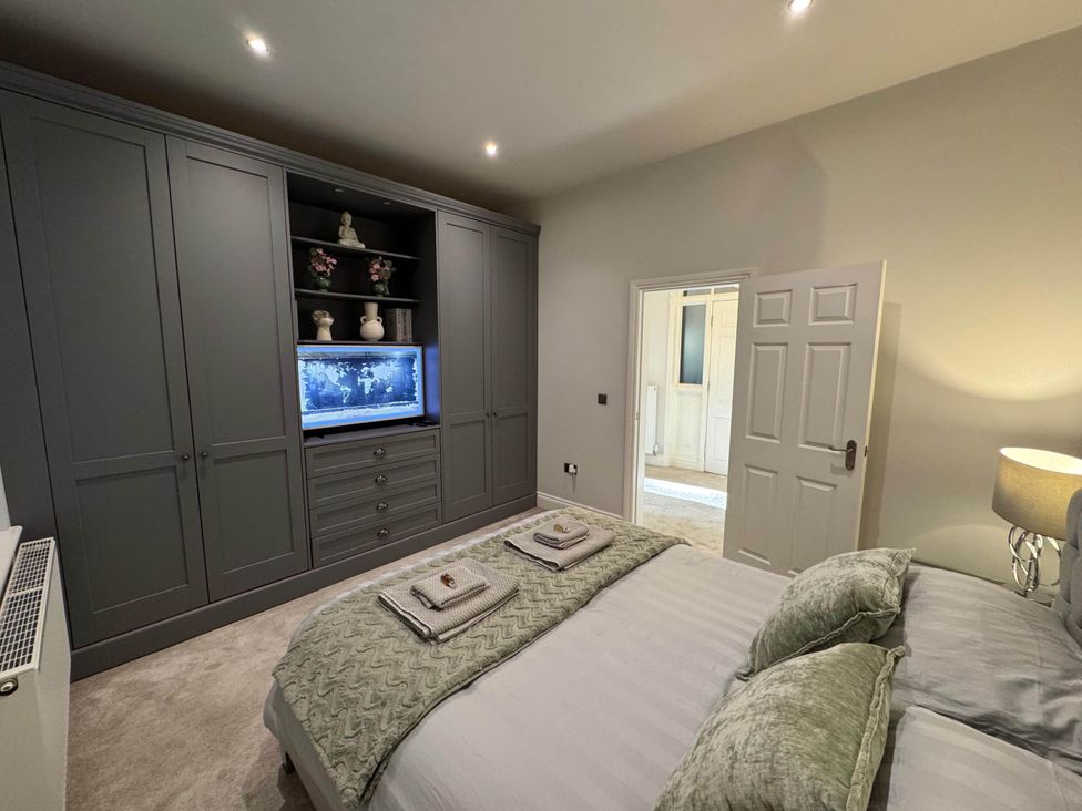 A bedroom with a bed and wardrobe at Apartment 2 in Preston, Lancashire
