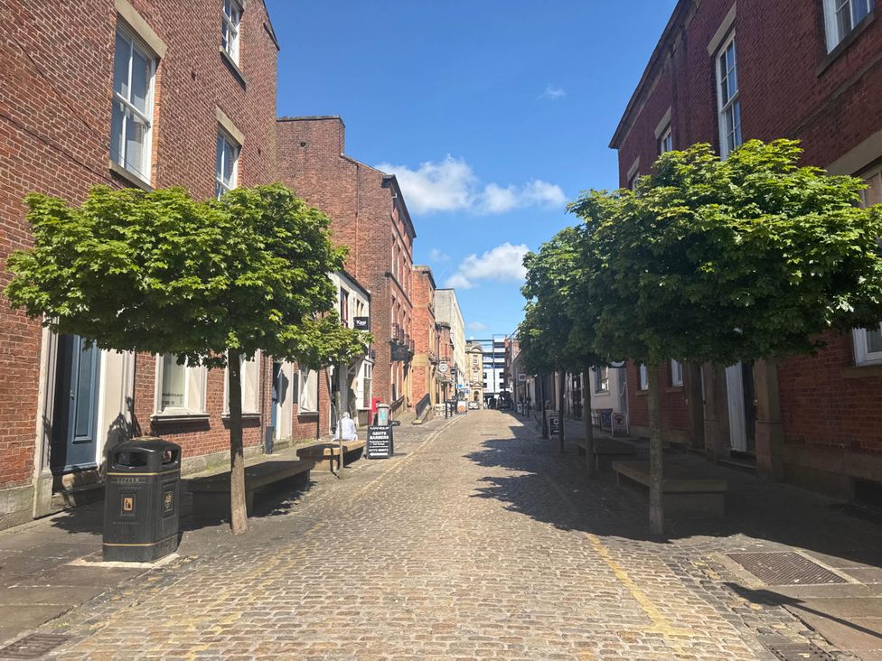 A street with trees and brick buildings at Apartment 2 Preston, Lancashire