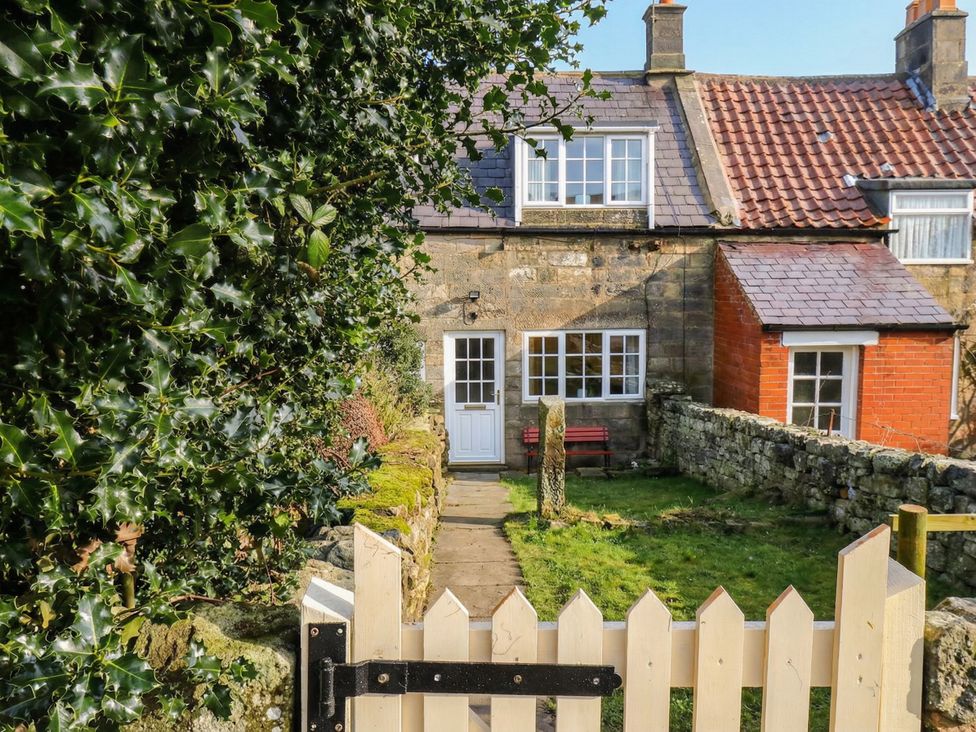 A cottage entrance with a pathway and gate at 4 Lilac Cottages