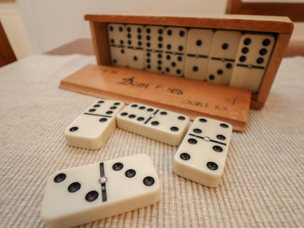 A set of dominoes with a box on a table at 4 Lilac Cottages