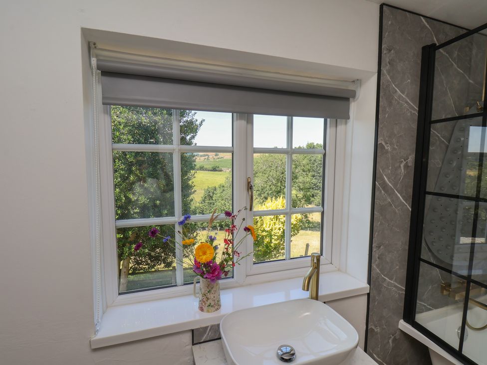A bathroom with a window and a sink at 4 Lilac Cottages Ainthorpe