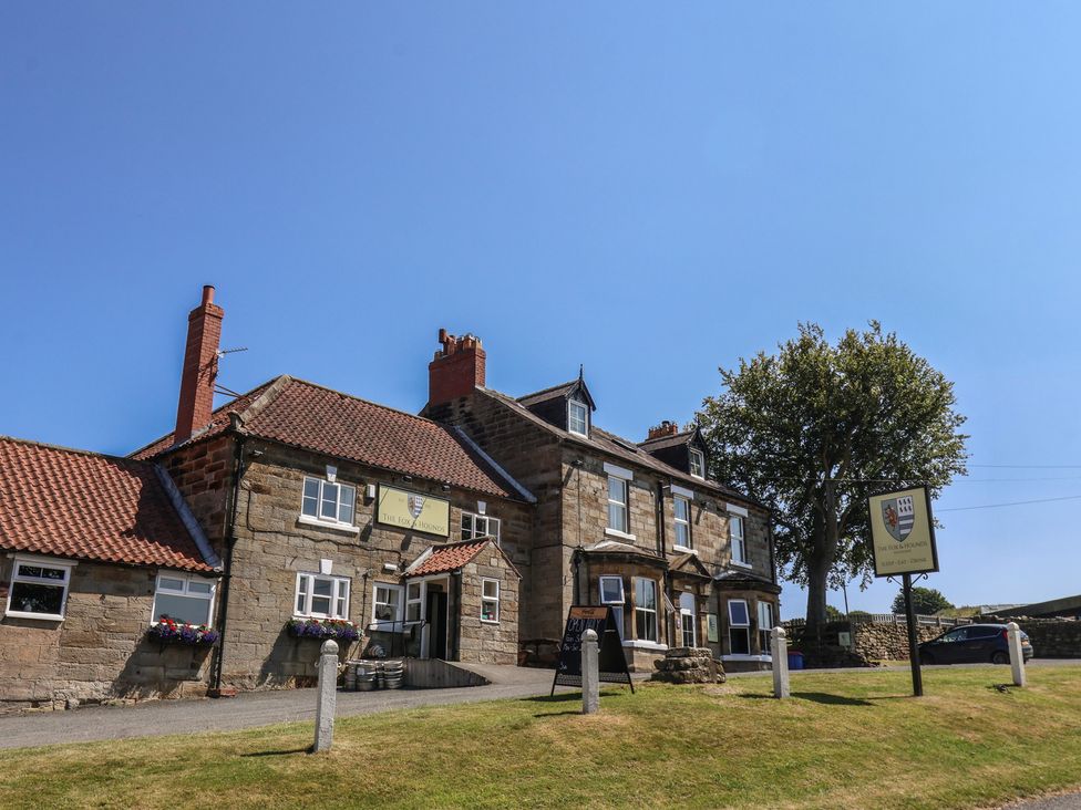 A building with sign and trees at 4 Lilac Cottages in Ainthorpe