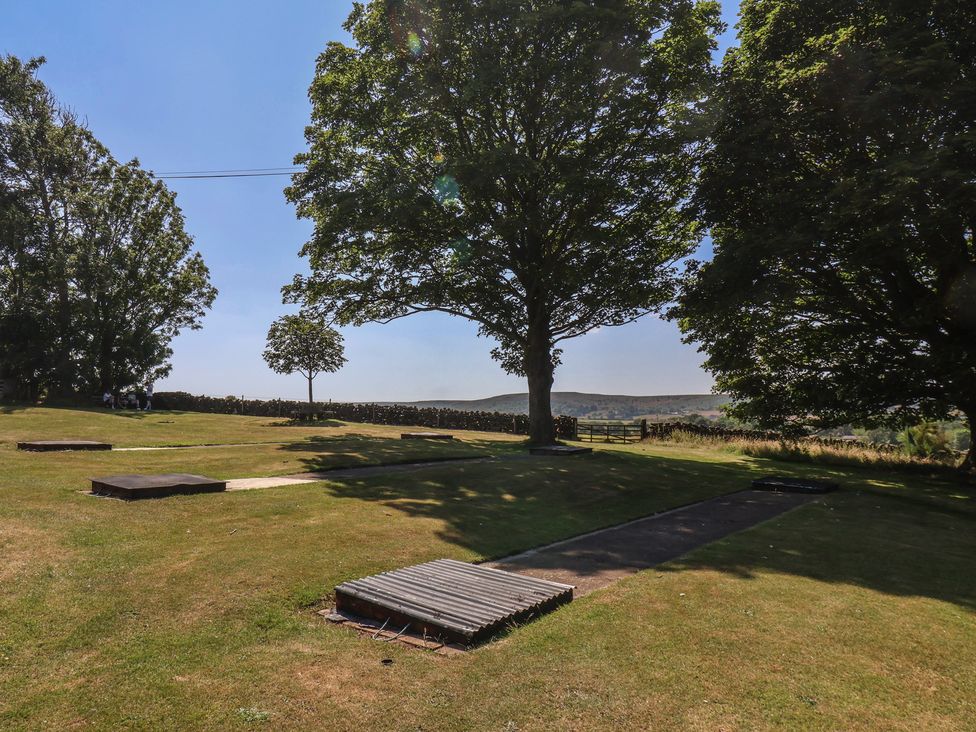 An outdoor area with grass and trees at 4 Lilac Cottages Ainthorpe