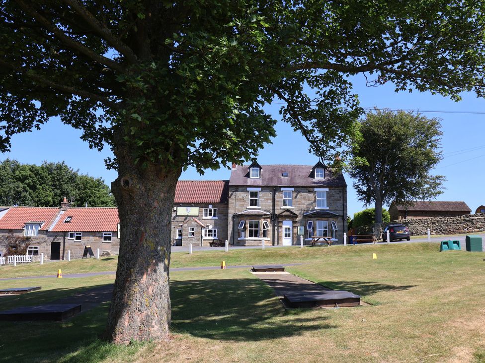 An outdoor area with a building and trees at 4 Lilac Cottages Ainthorpe