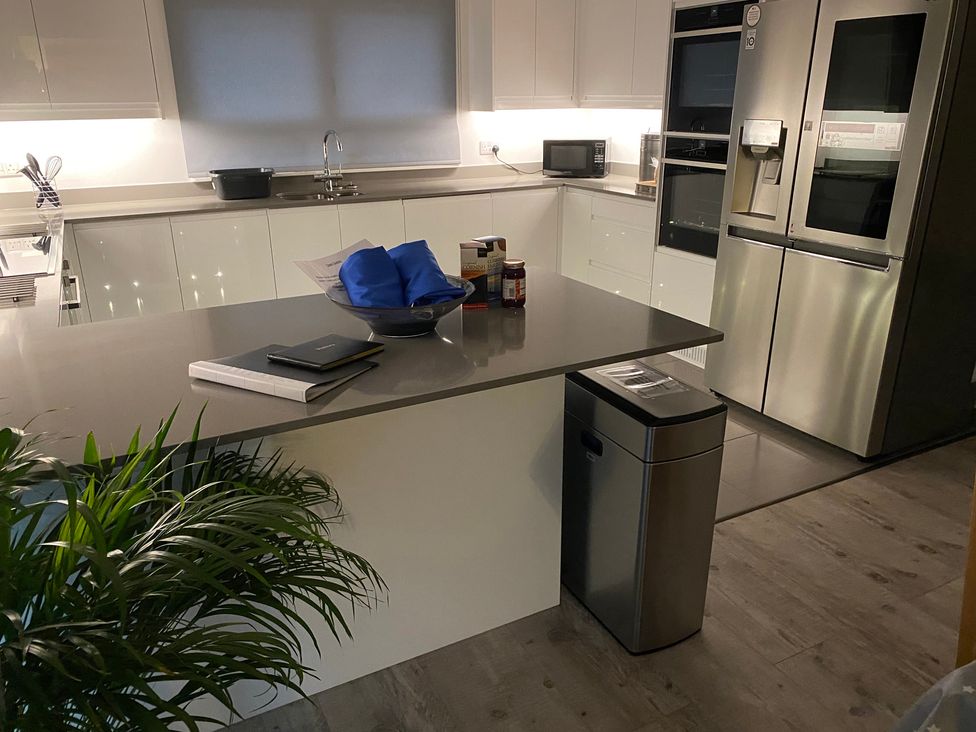 A kitchen with a countertop, sink, and appliances at Pityme-Not in Wadebridge