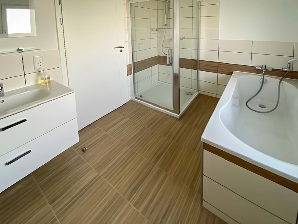 A bathroom with a shower and bathtub at Pityme-Not Wadebridge