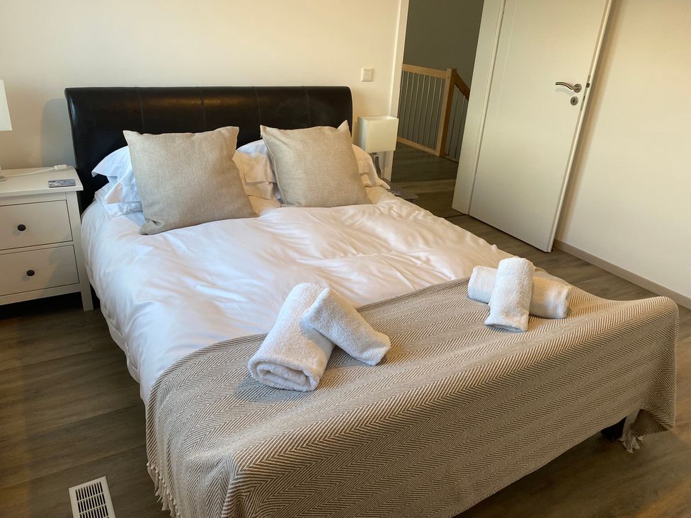 A bedroom with a bed and bedside table at Pityme-Not in Wadebridge