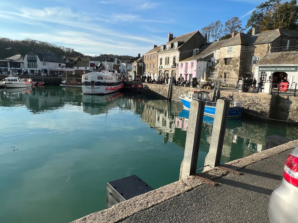 A harbor with boats and buildings at Pityme-Not in Wadebridge