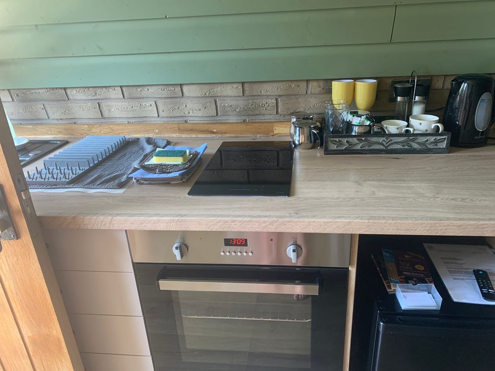 A kitchen with an oven and stove top at Cosy Escape in Sheerness