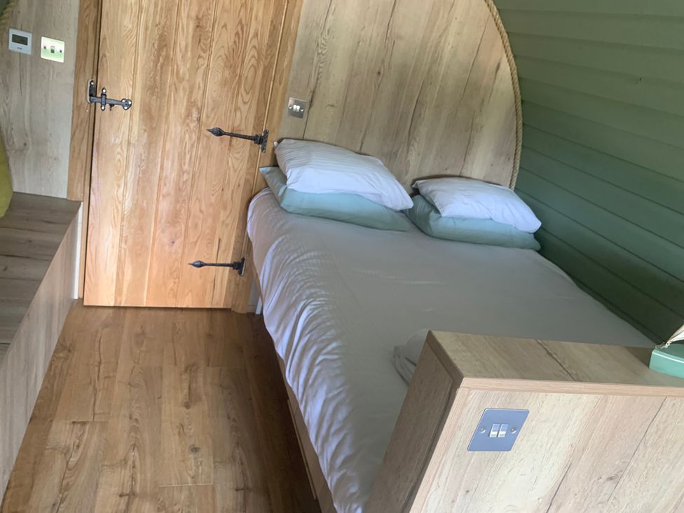A bedroom with a bed and wooden door at Cosy Escape in Sheerness