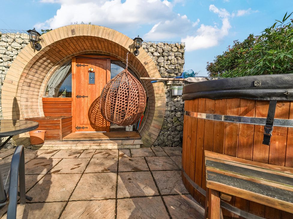 An outdoor area with a door and a hot tub at Cosy Escape in Minster On Sea