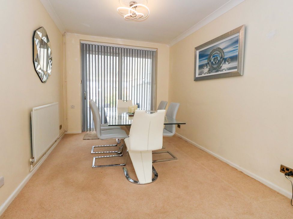 A dining room with a table and chairs at 15 Coombe Avenue 