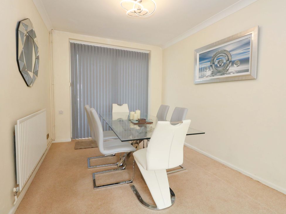 A dining room with a table and chairs at 15 Coombe Avenue