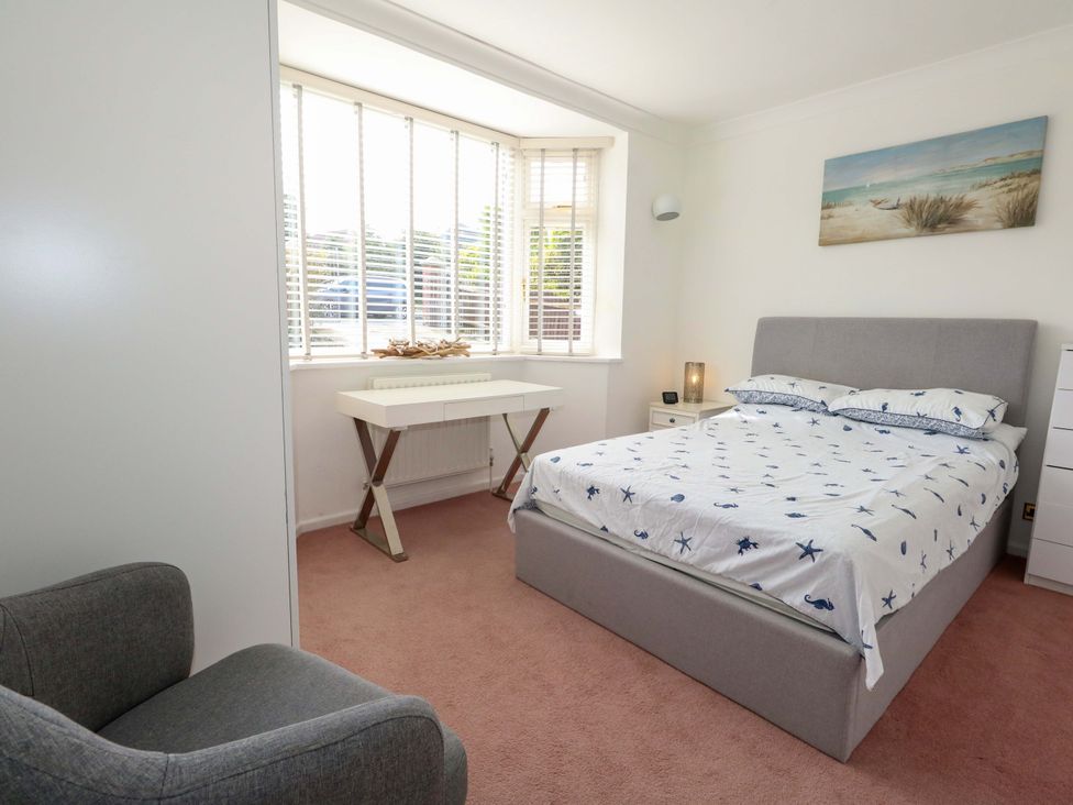 A bedroom with a bed and a table at 15 Coombe Avenue