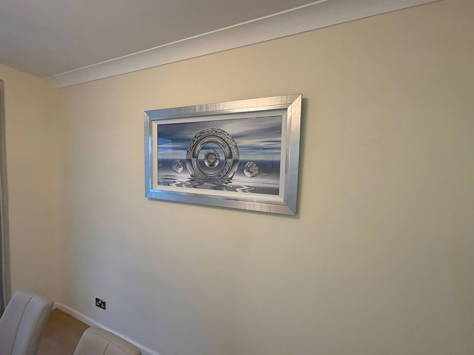 A framed artwork on a wall at Tudor Rose Weymouth
