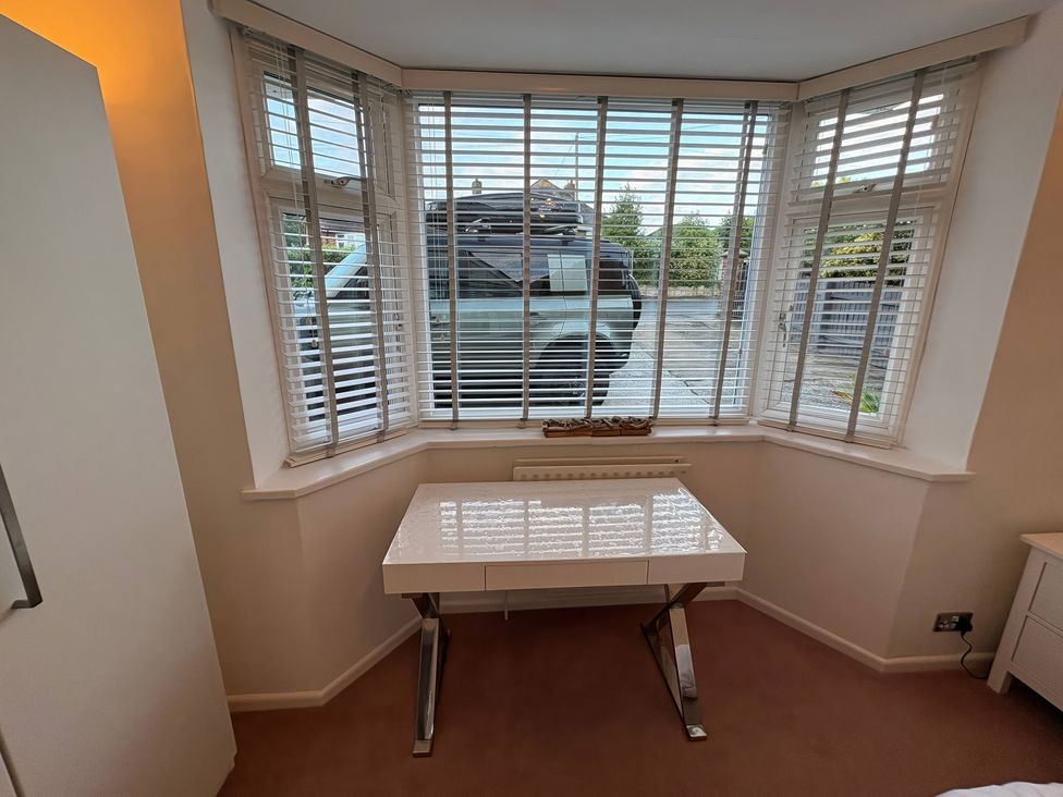An office with a desk and blinds at Tudor Rose in Weymouth