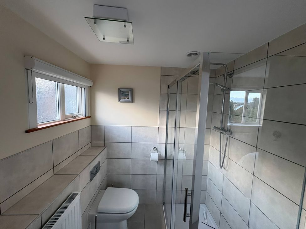 A bathroom with a shower and toilet at Tudor Rose in Weymouth