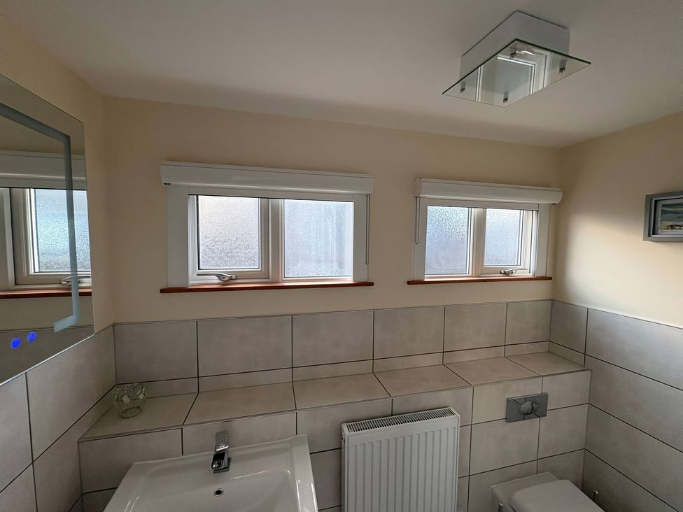 A bathroom with a sink and toilet at Tudor Rose in Weymouth