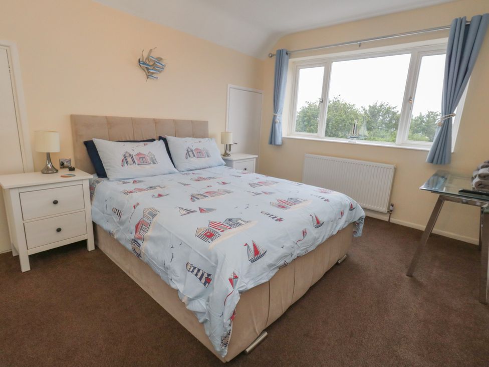 A bedroom with a bed and bedside tables at Tudor Rose in Weymouth