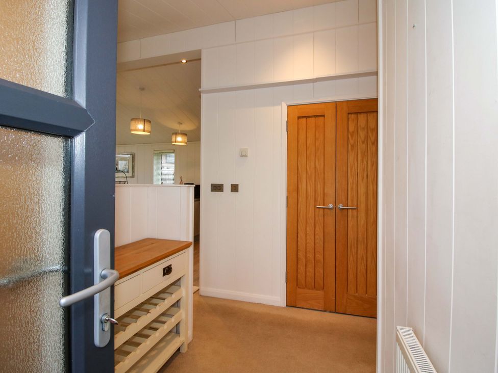 An entryway with a cupboard and doors at 5 Hillview Lodges Cleobury Mortimer