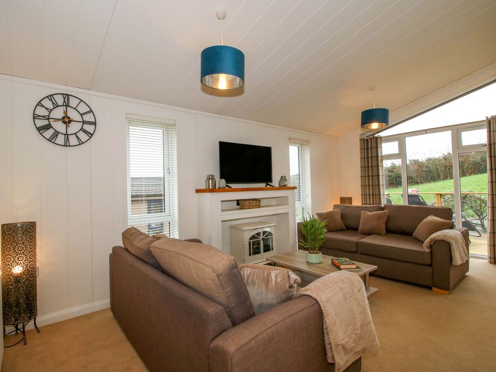 A living room with a television and sofa at 5 Hillview Lodges in Cleobury Mortimer