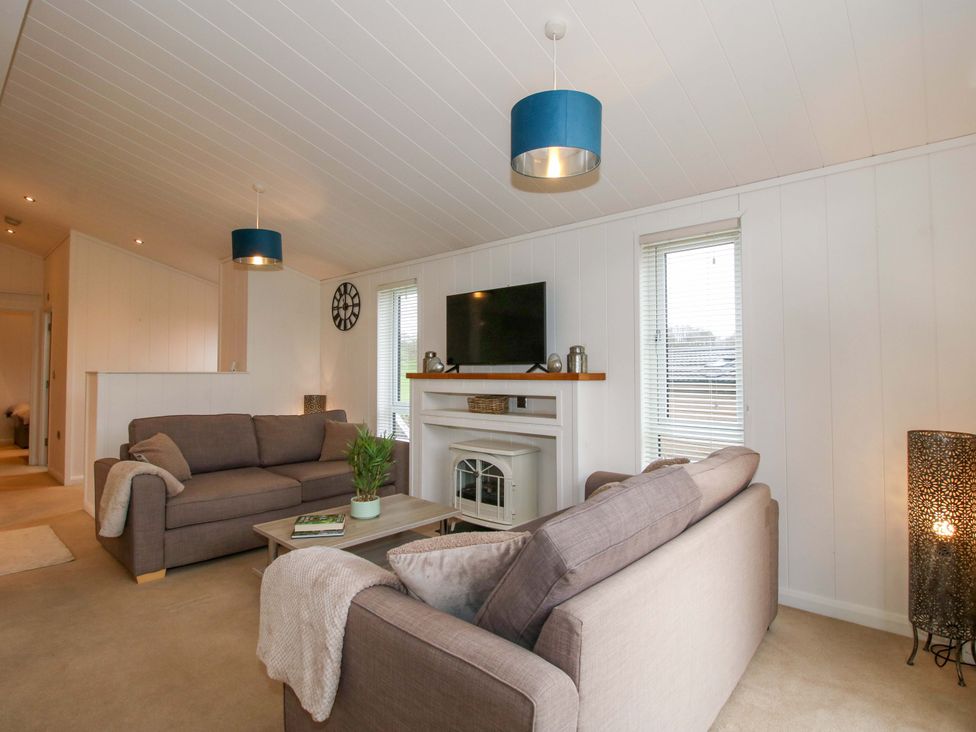 A living room with a television and sofas at 5 Hillview Lodges in Cleobury Mortimer