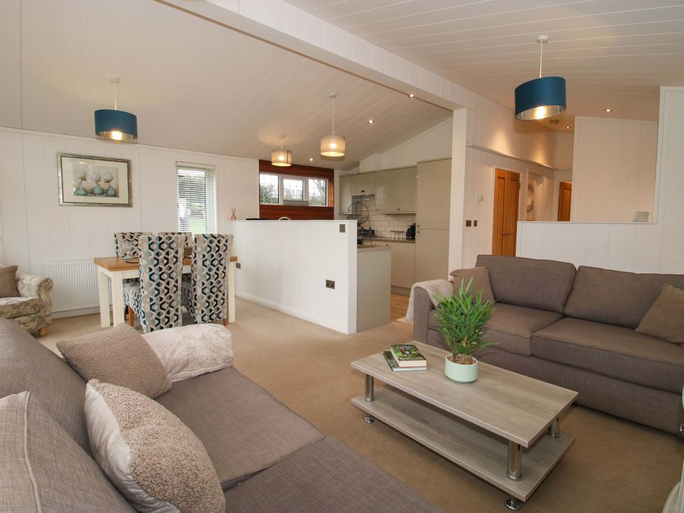 A living room with a coffee table and dining area at 5 Hillview Lodges Cleobury Mortimer