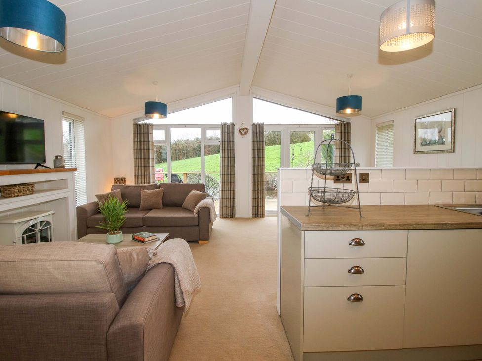 A living room with a sofa and television at 5 Hillview Lodges in Cleobury Mortimer
