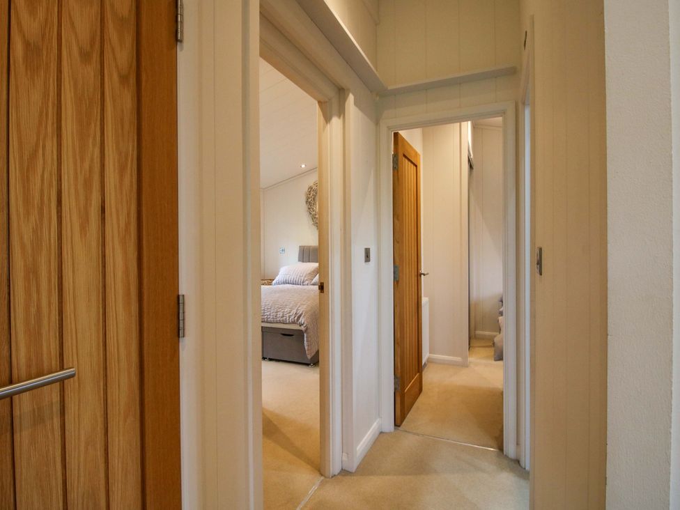 A hallway with multiple doors at 5 Hillview Lodges Cleobury Mortimer
