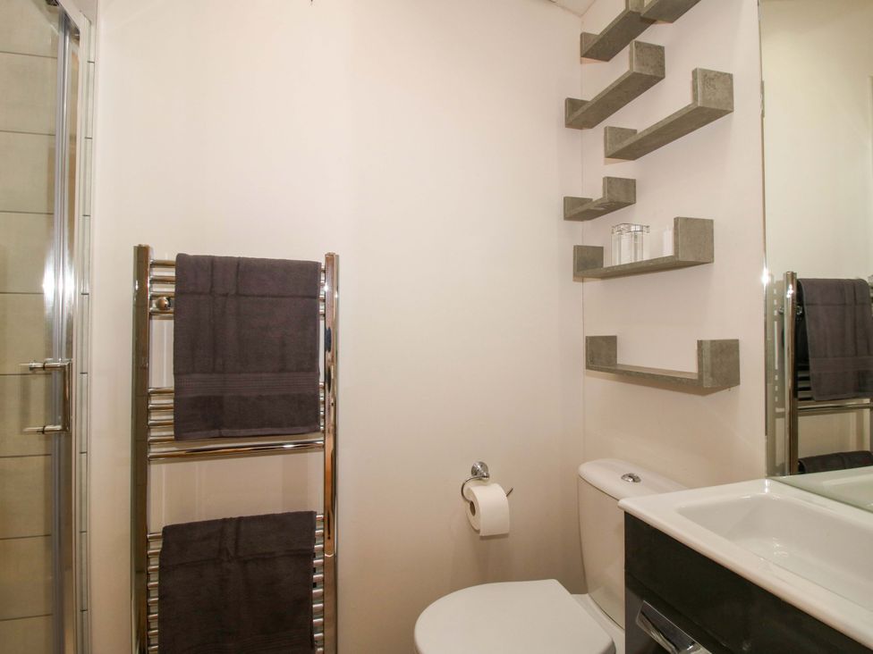 A bathroom with a towel rack and a shower at 5 Hillview Lodges Cleobury Mortimer