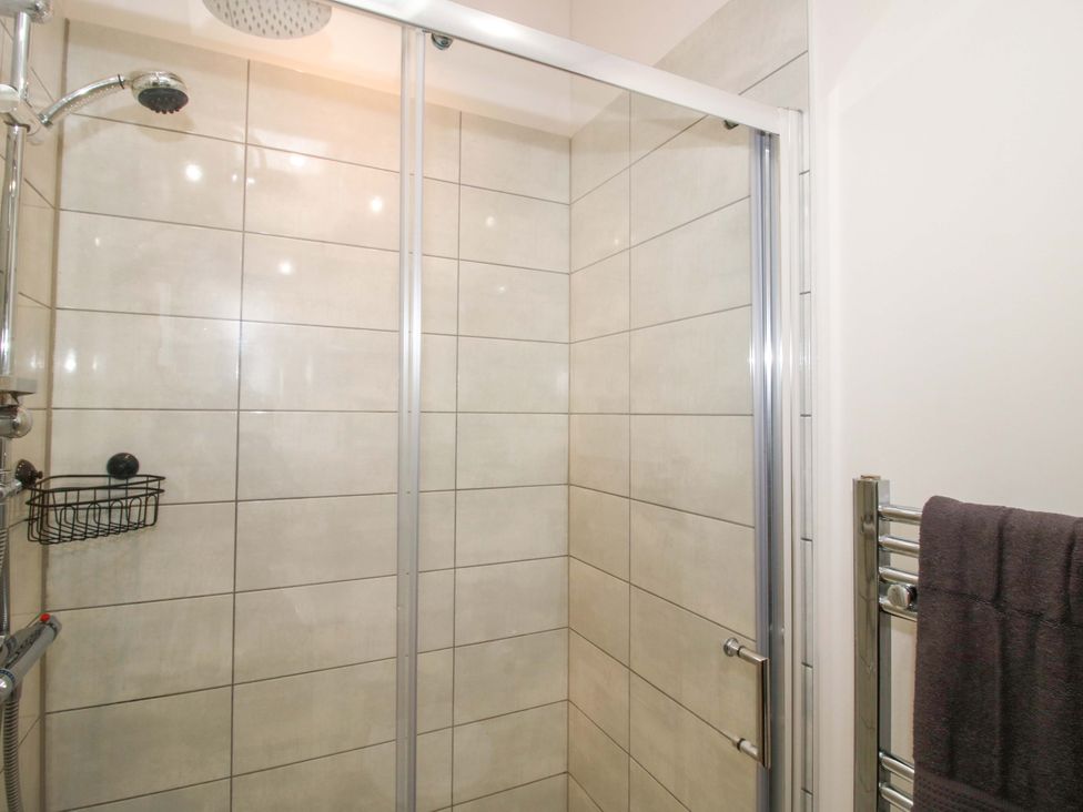 A shower area with tiles and a towel rail at 5 Hillview Lodges Cleobury Mortimer
