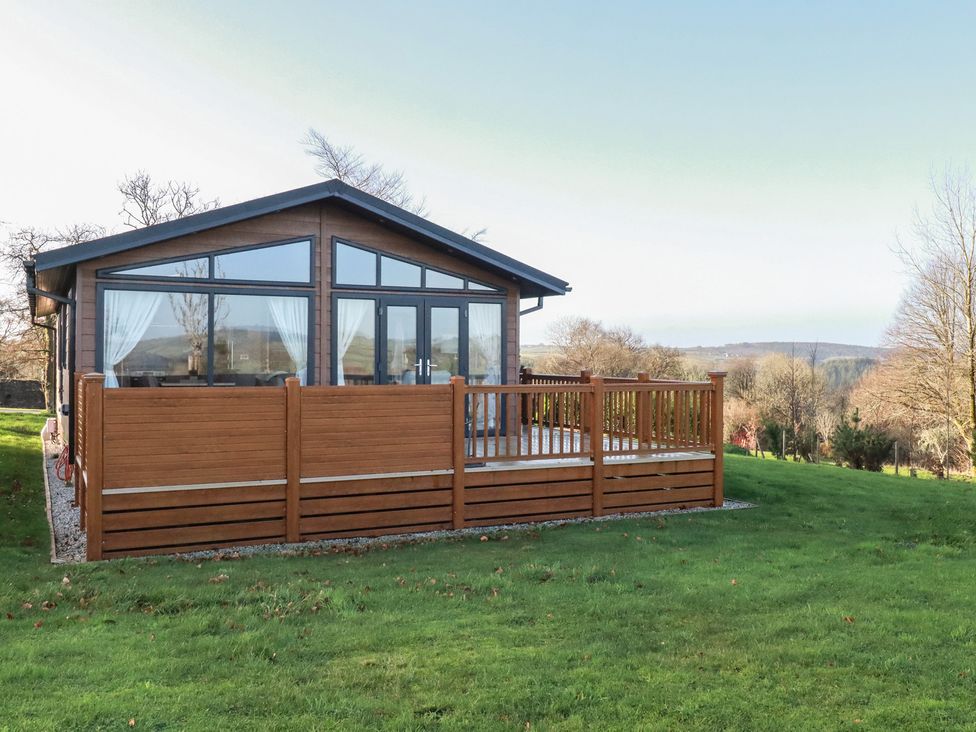 A wooden deck with a house at Moorland View in 