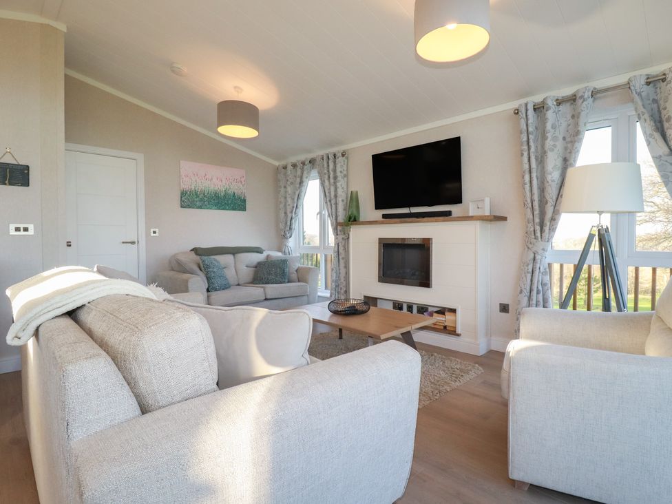 A living room with a sofa and television at Moorland View