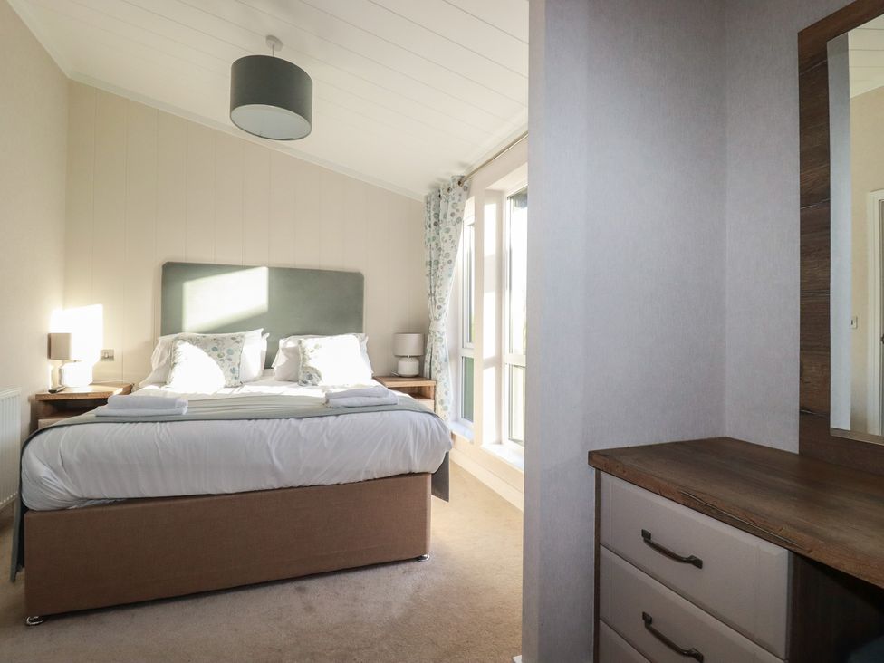 A bedroom with a double bed and dressing table at Moorland View