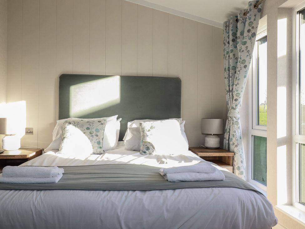 A bedroom with a bed and lamp at Moorland View in 