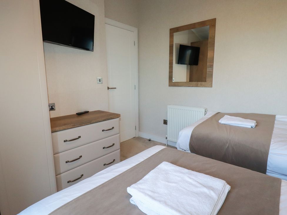 A bedroom with two beds and a television at Moorland View in 