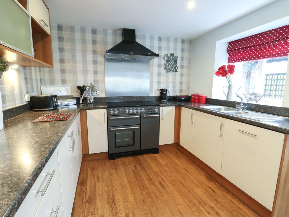 A kitchen with a stove and sink at Ty Llyn in Brynteg near Benllech
