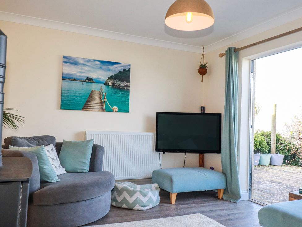 A living room with a sofa and television at 3A Grannys Lane Perranporth